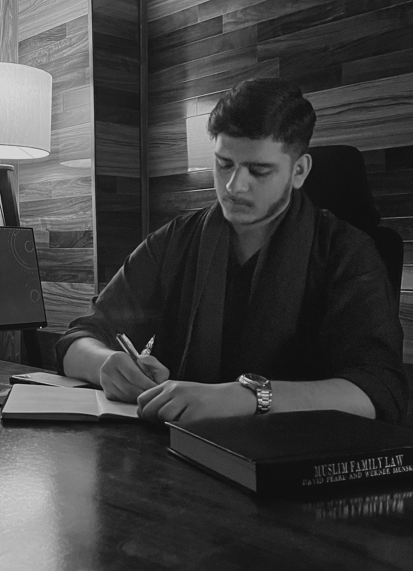 Founder writing at desk